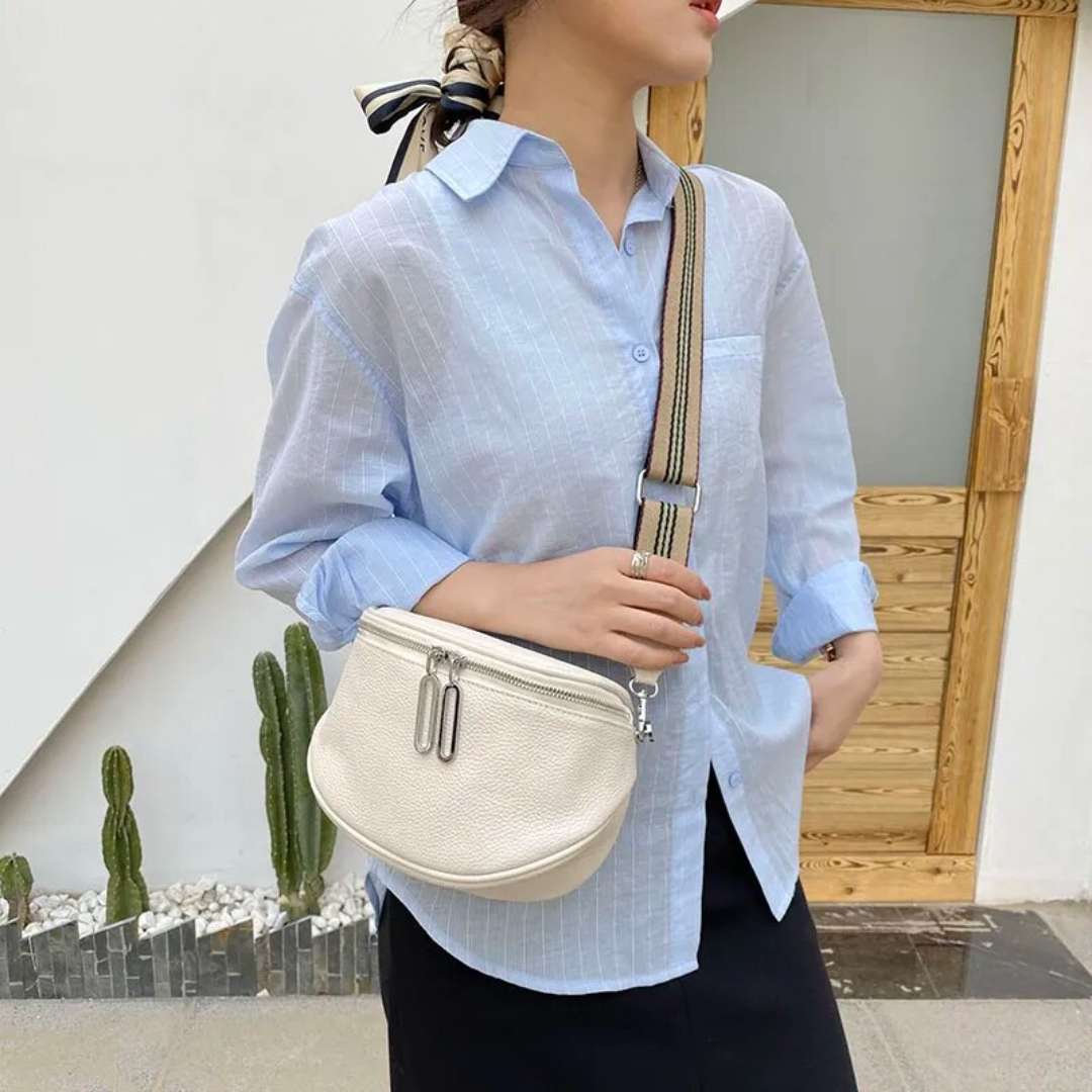 Compact leather saddle bag worn crossbody for an everyday styling view