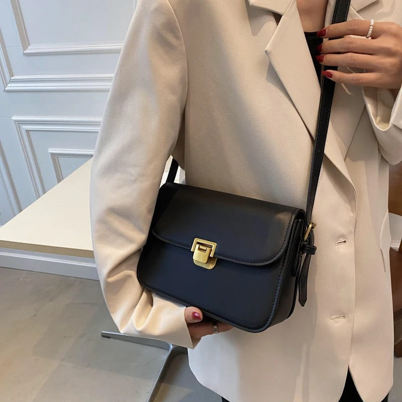 Women's leather shoulder bag shown from the front with a structured silhouette
