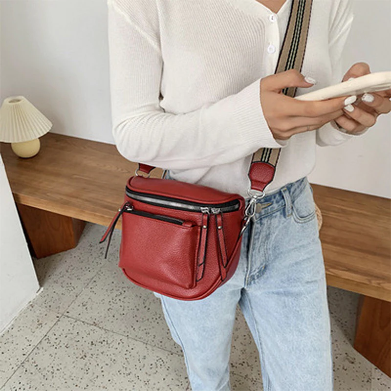 Side view of the leather crossbody bag showing slim profile