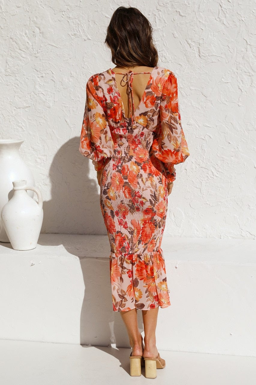 Close-up of the orange floral pattern and long sleeves on the Ibiza dress