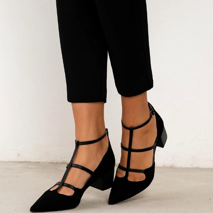 Side view of women's pointed-toe flats featuring secure ankle straps