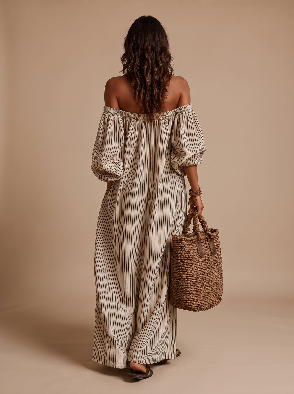 Full-length view of a women's striped off-shoulder maxi dress