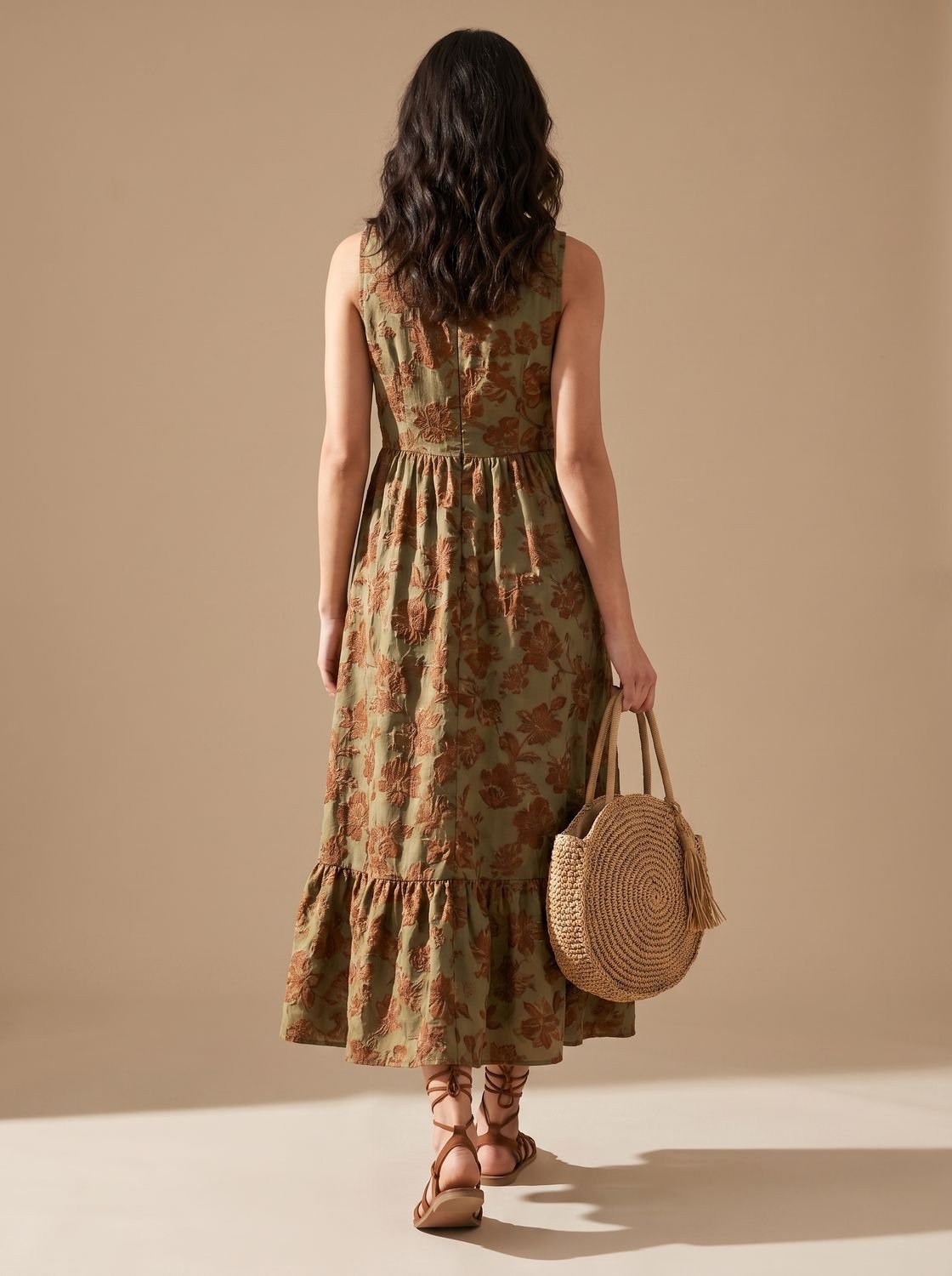 Close-up of the one-shoulder neckline and floral fabric on the maxi dress