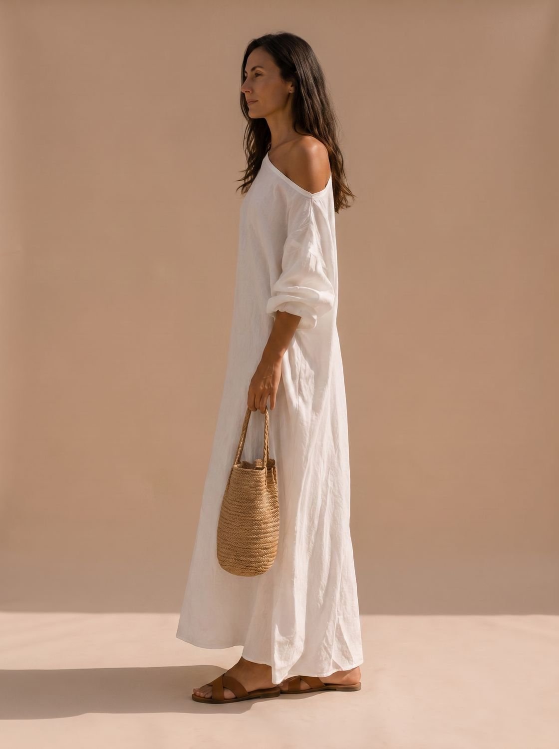 Side view of a women's linen maxi dress with a one-shoulder neckline and wide sleeve