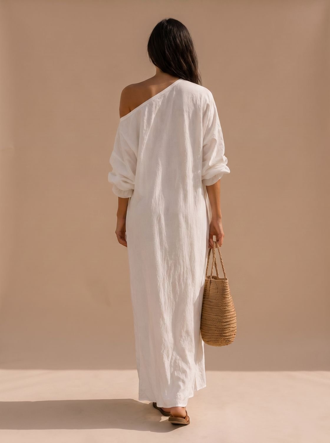 Close-up of the one-shoulder neckline and wide sleeve on a linen maxi dress