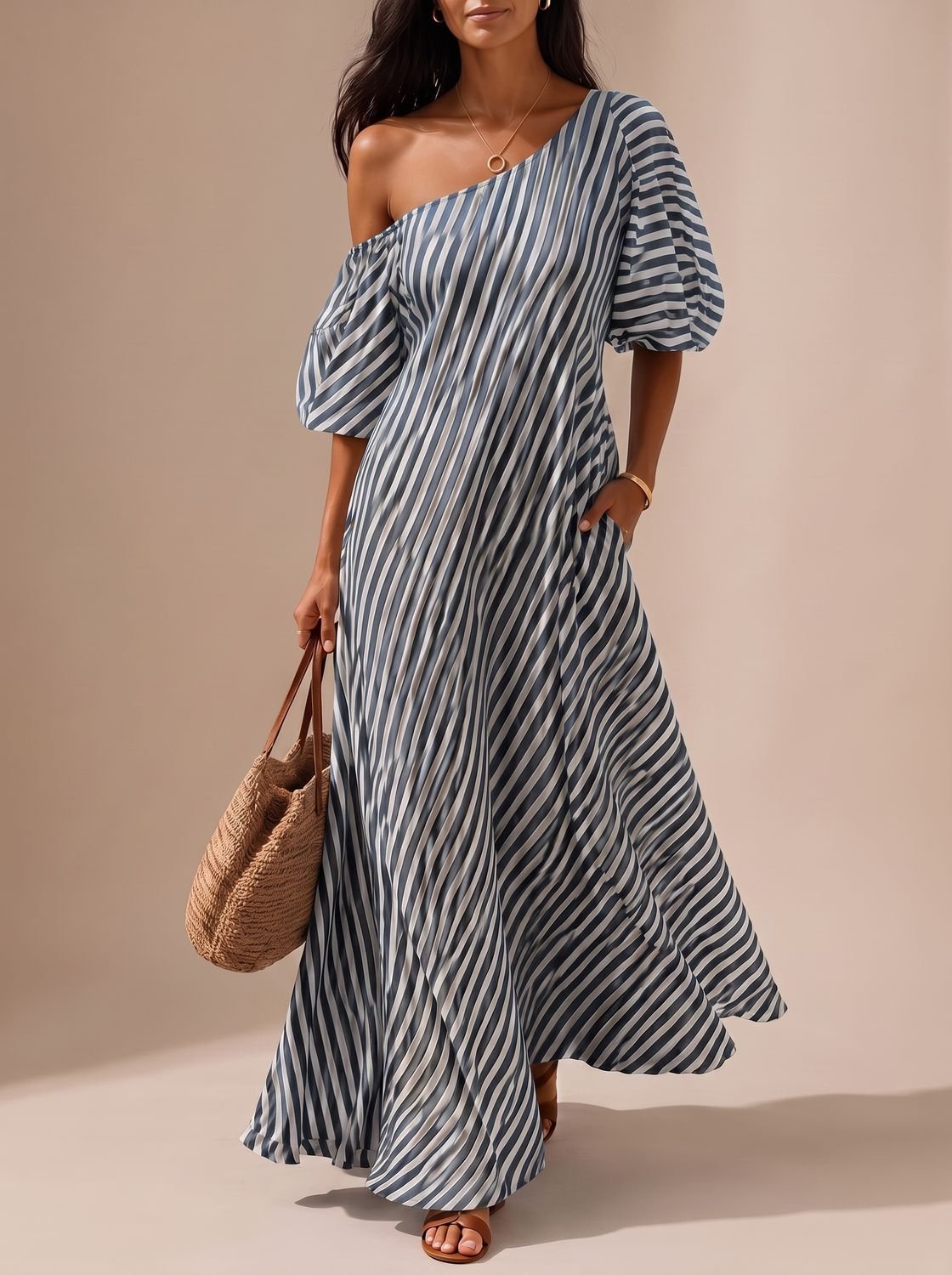 Detail view of the one-shoulder neckline on a striped maxi dress