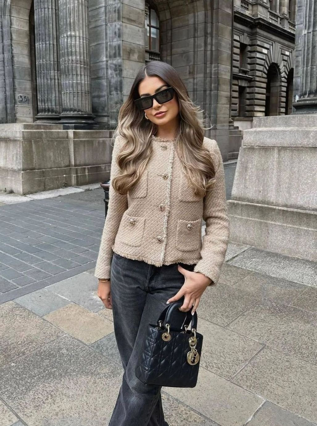 Side view showing the cropped length and tailored shape of the tweed blazer