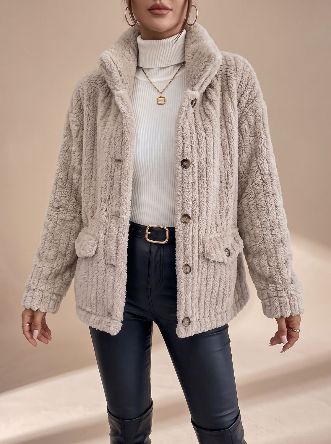 Women's faux fur coat displaying its practical side pockets