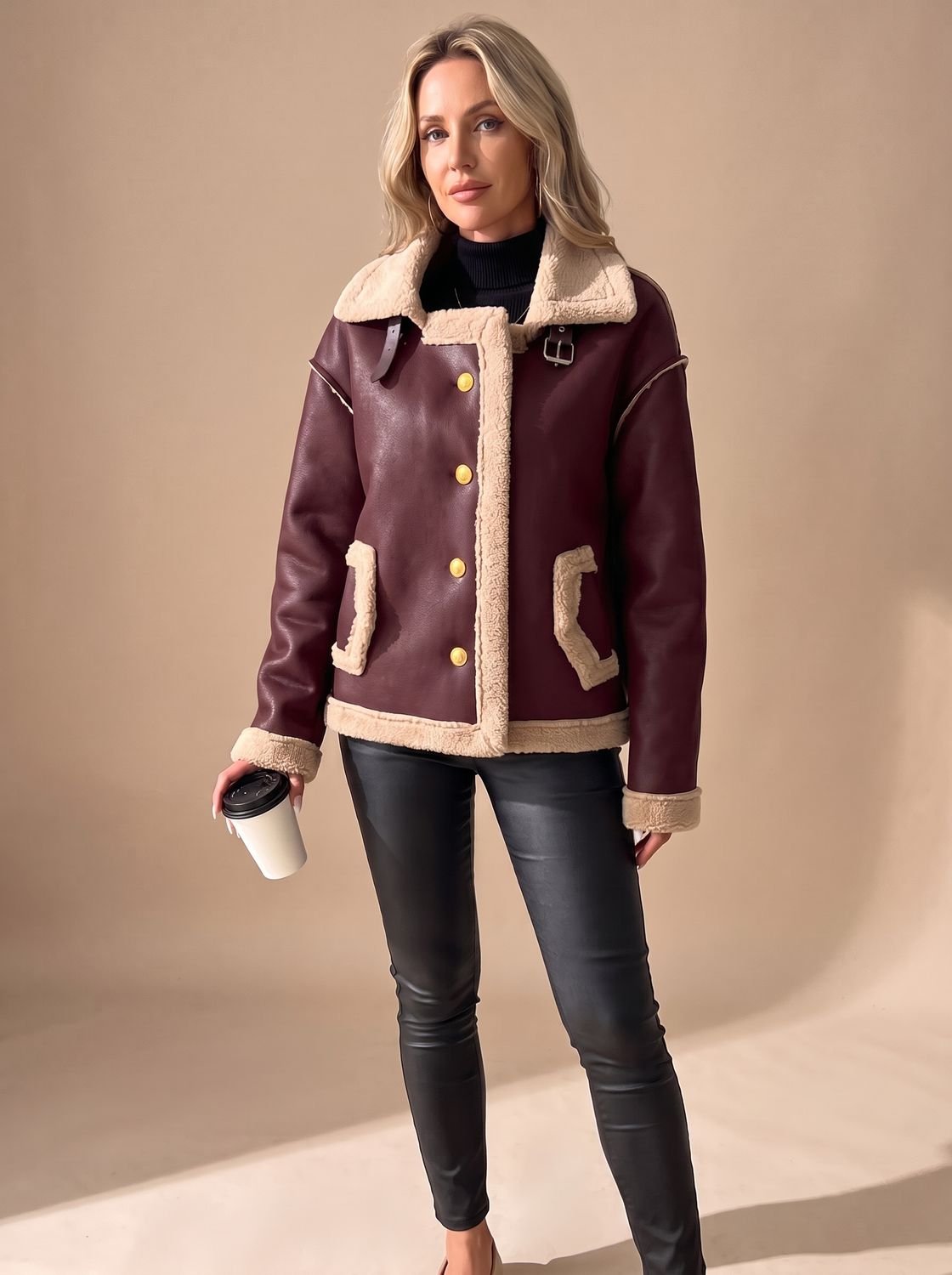 Close-up of the button-front closure on a faux leather women's jacket