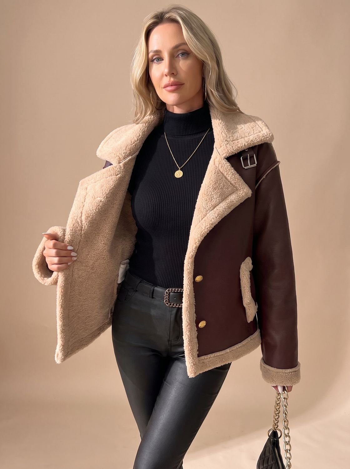 Side view of a sherpa-lined faux leather aviator jacket for women