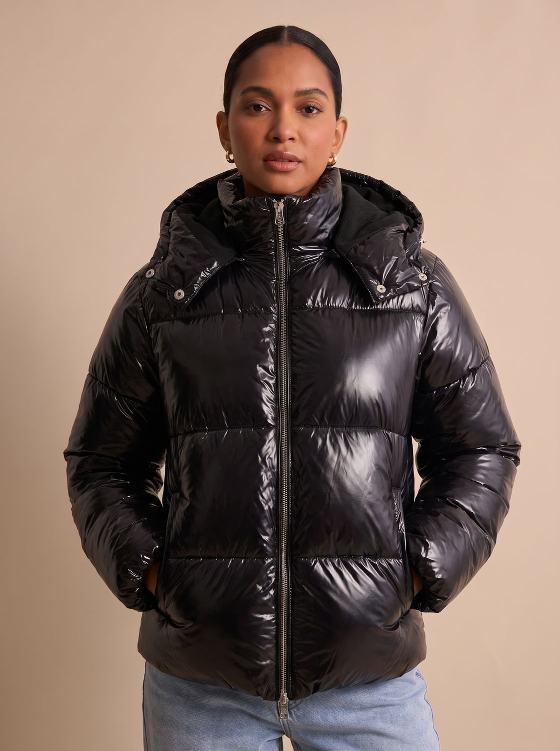 Side view of a women's hooded quilted puffer jacket