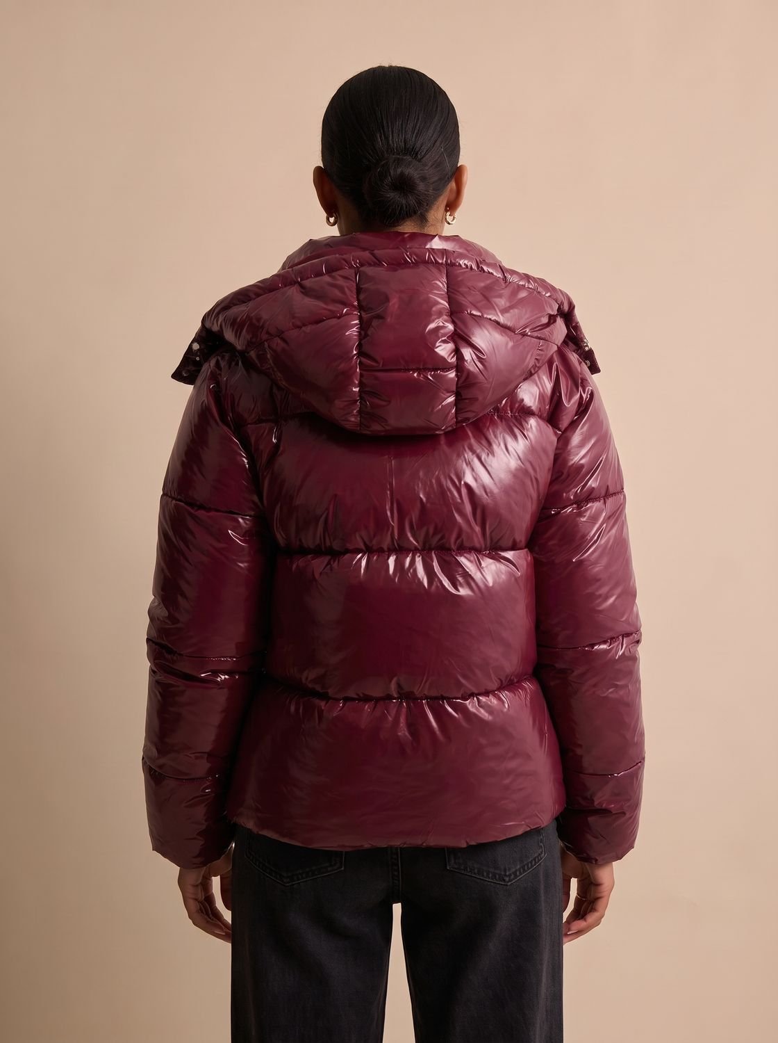 Close-up of the hood, quilting, and front closure on a women's puffer jacket