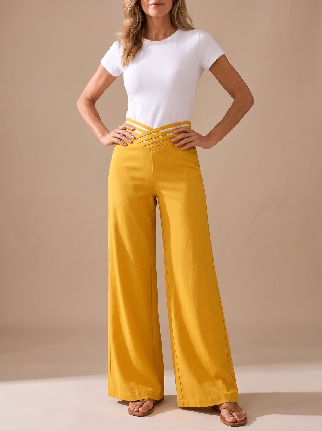 Women's crossover-waistband pants shown in a relaxed standing pose