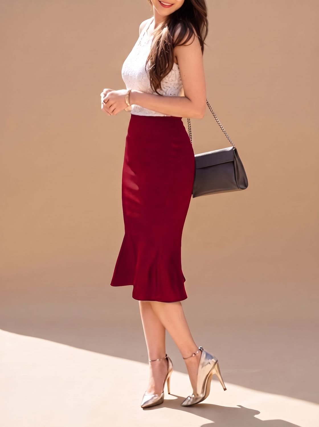 Model wearing a fitted high-waist midi pencil skirt with a fishtail hem