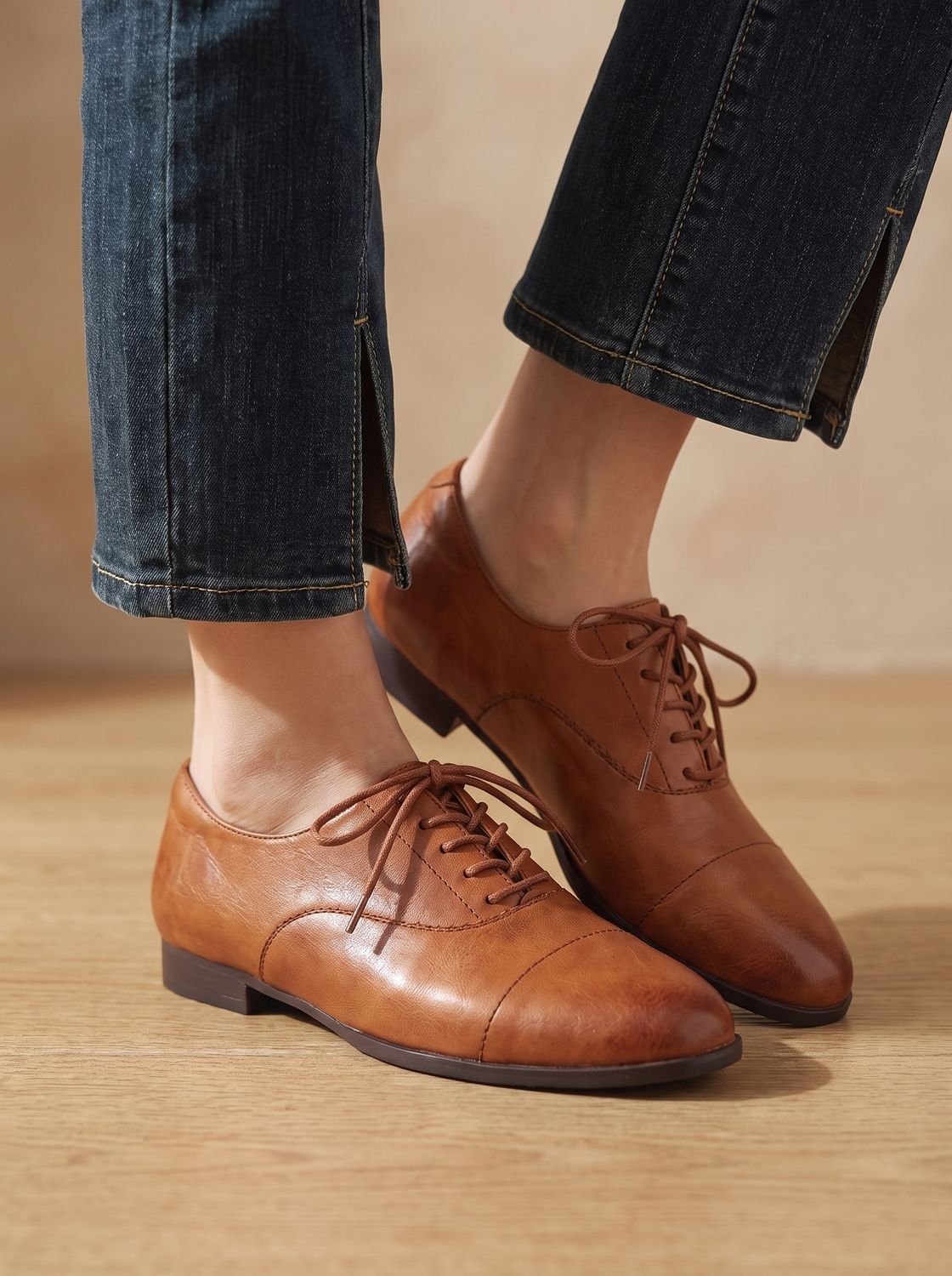 Women's Oxford flat shoe showing the classic cap toe design