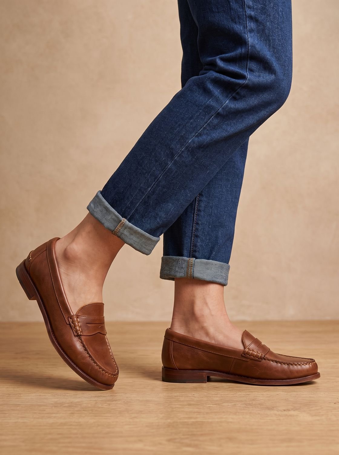 Close-up of moccasin stitching and penny strap on a leather loafer
