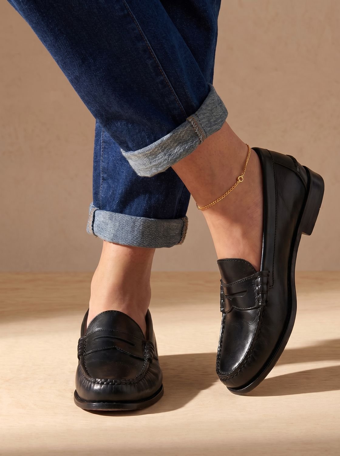 Pair of women's leather penny loafers styled as classic everyday footwear