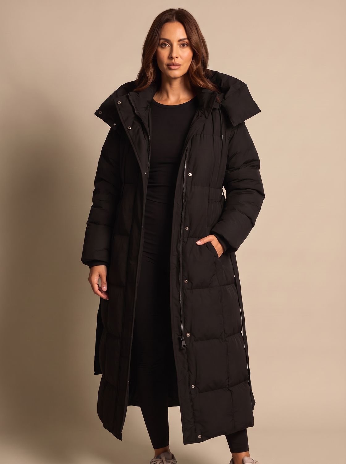Long women's puffer coat featuring a hood and full-length winter coverage