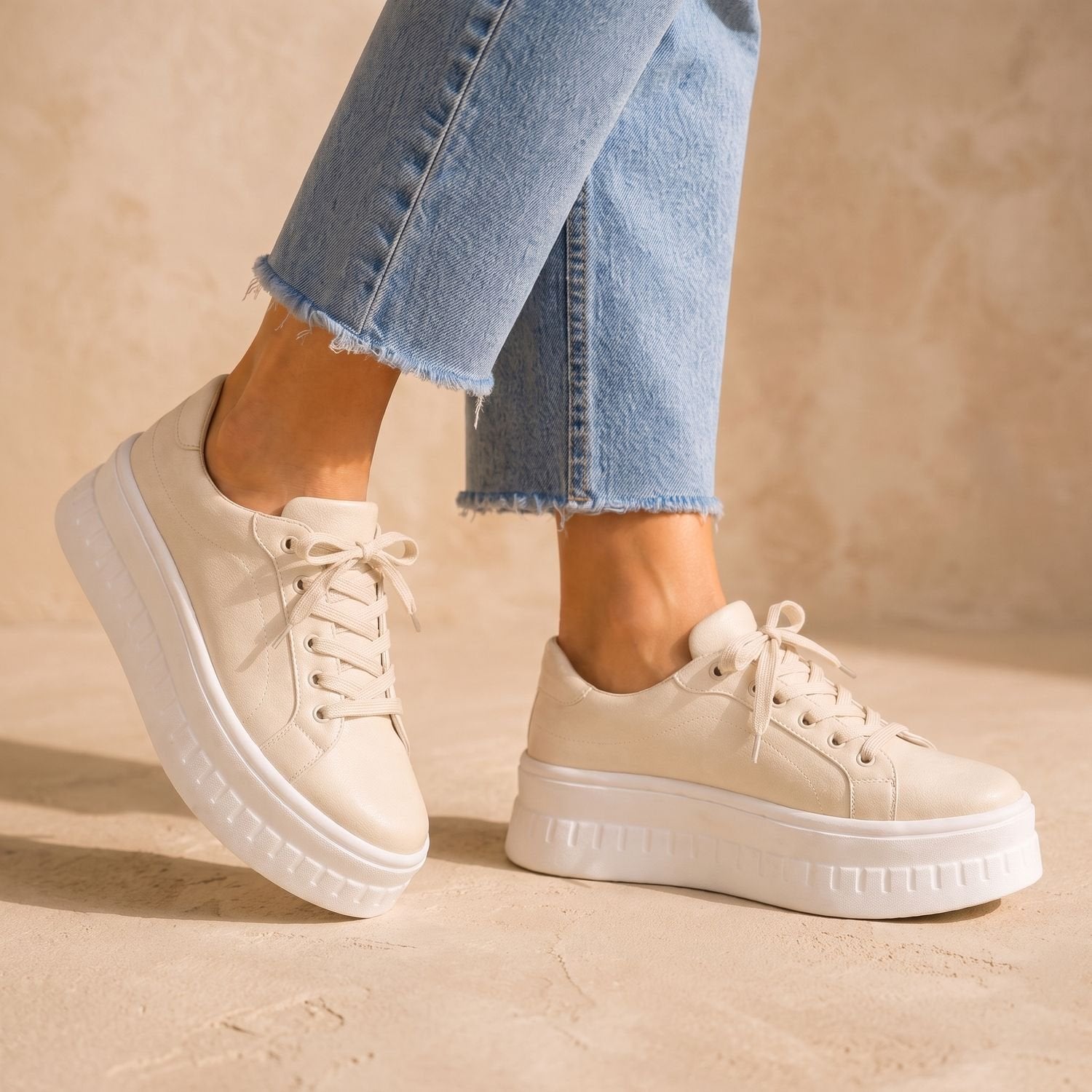 Women's tan platform sneakers displayed from a three-quarter view
