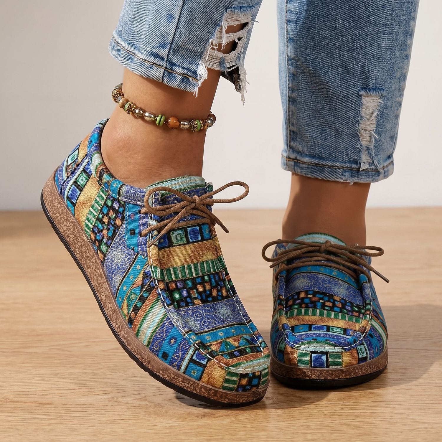 Women's lace-up sneakers showing the cushioned low-profile sole