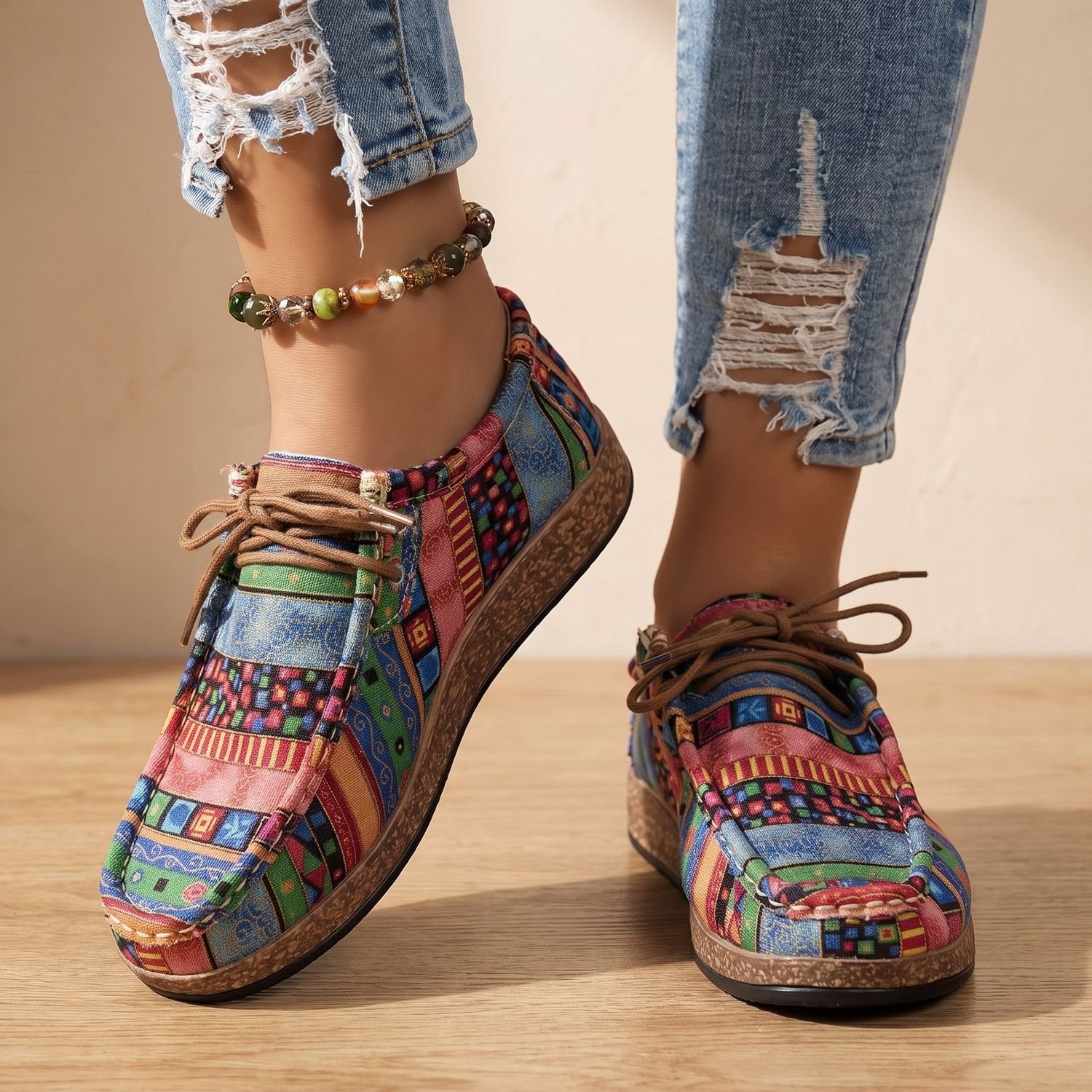Detailed view of the eyelets and laces on women's patchwork sneakers