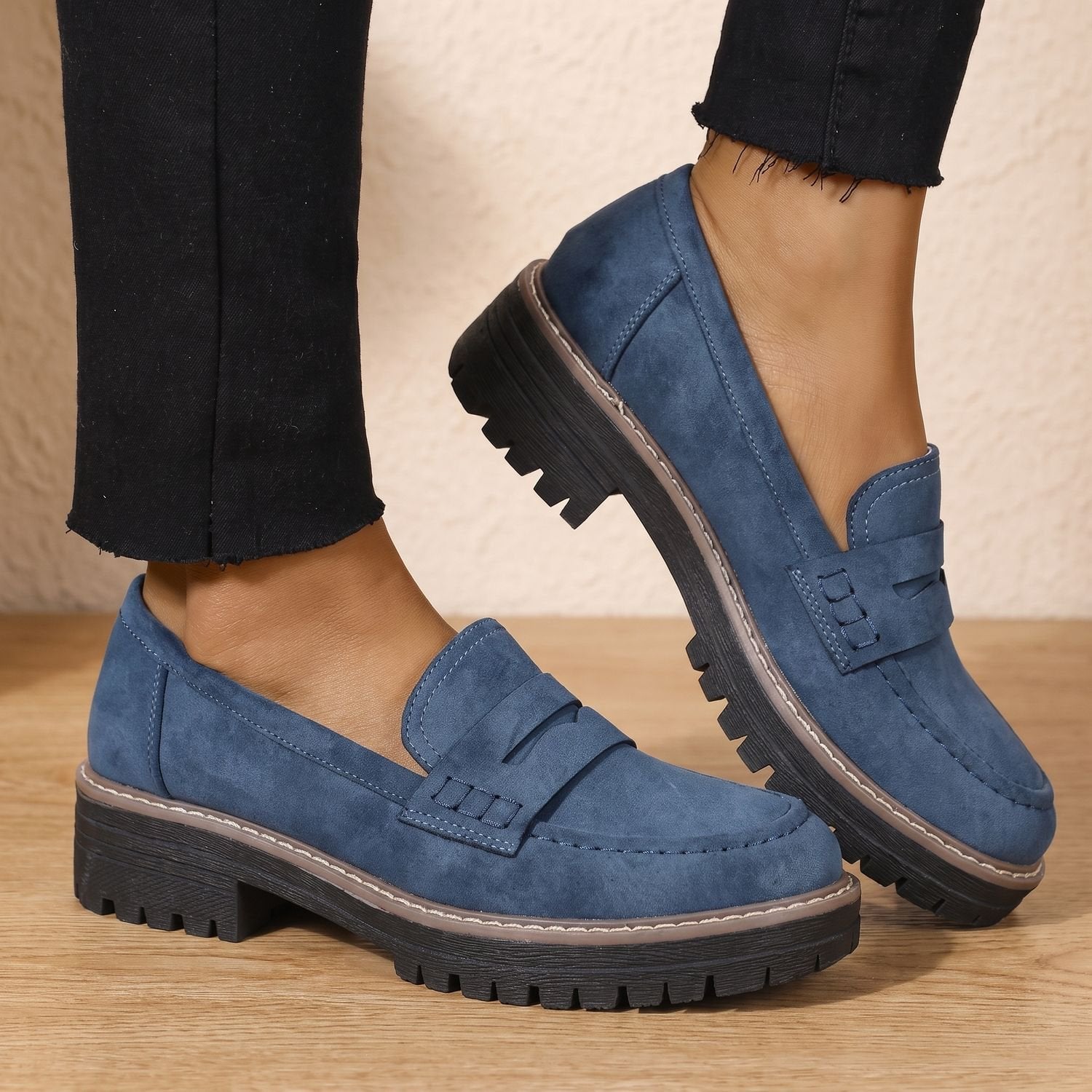 Pair of women's platform penny loafers shown from the side