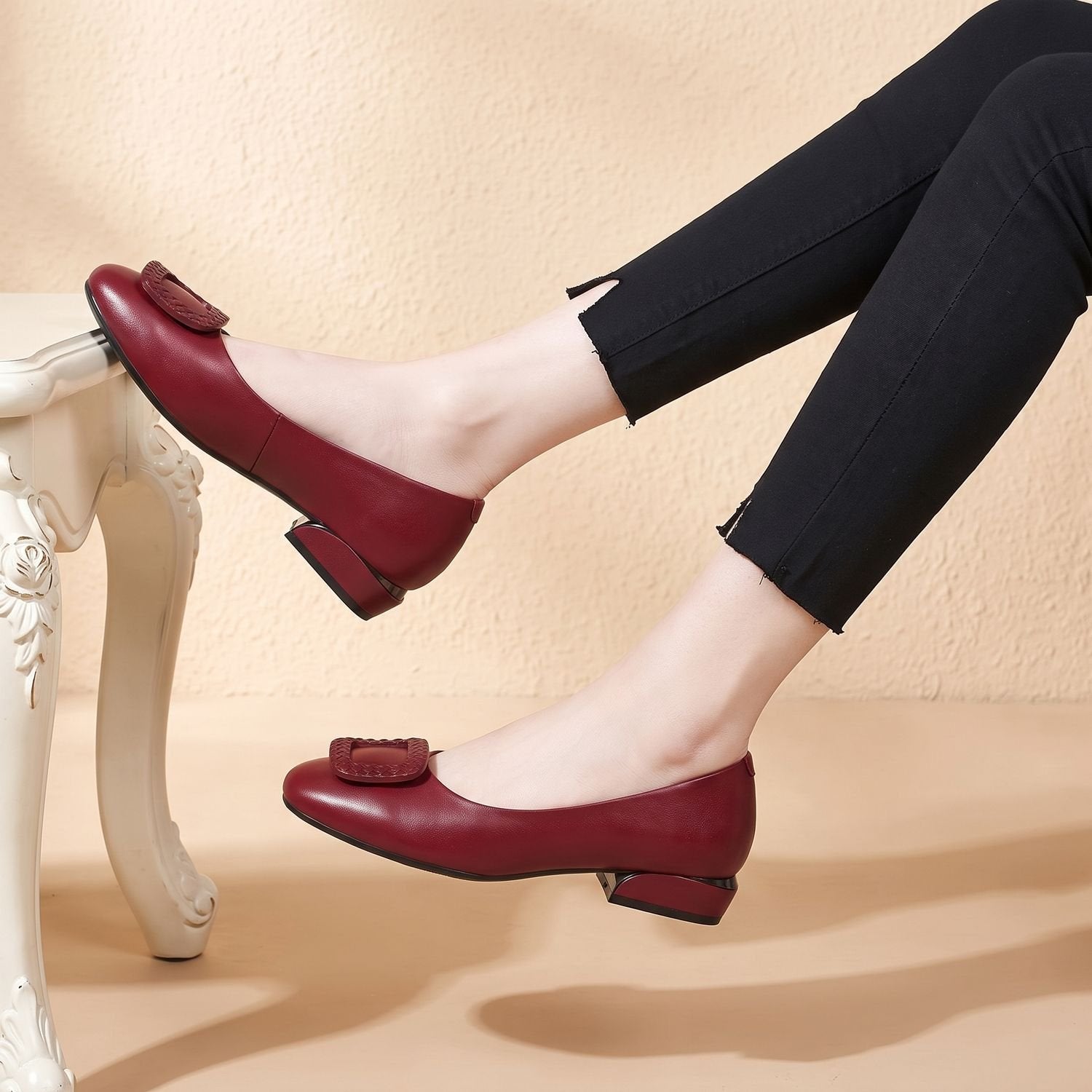 Women's leather block-heel loafer pumps shown from the side