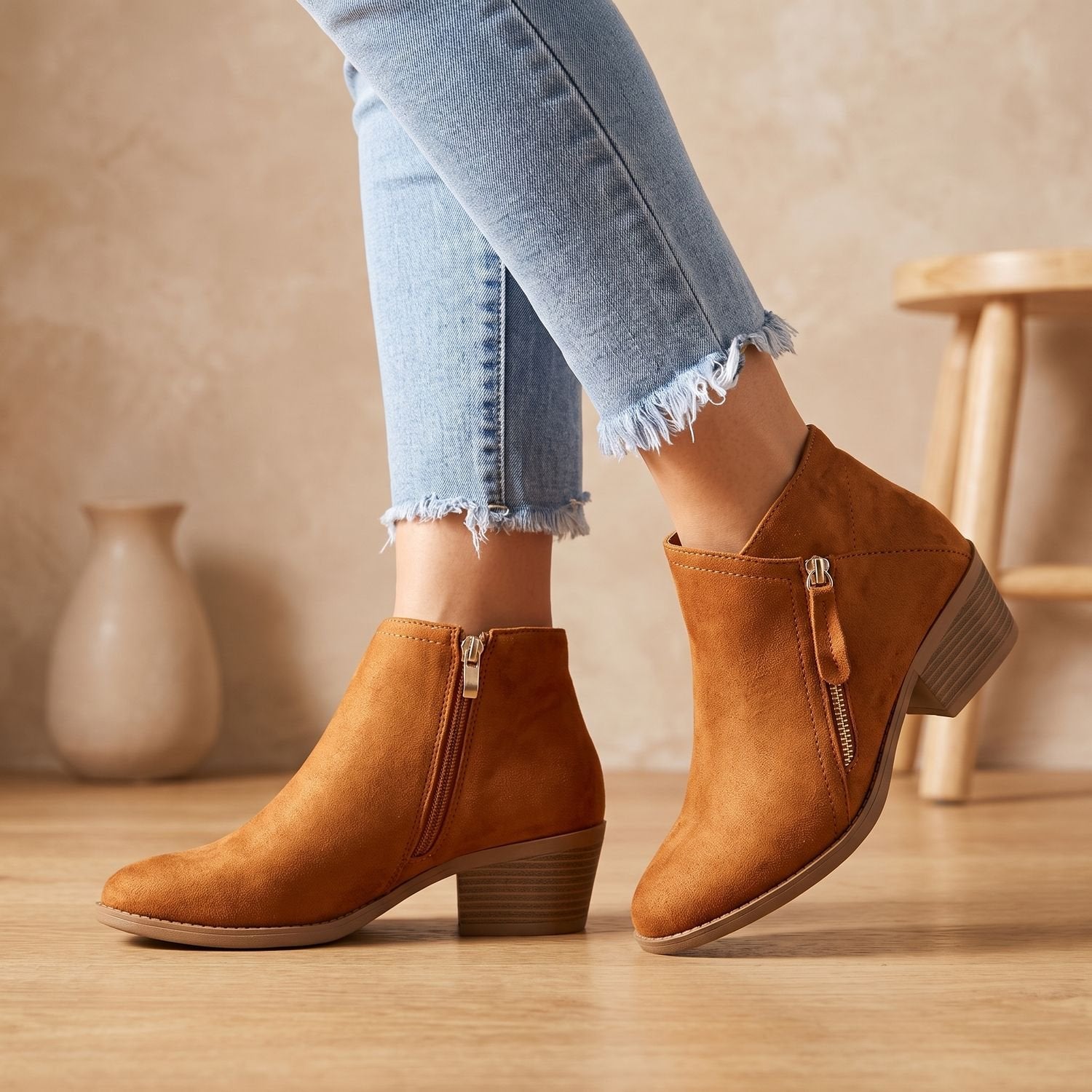 Side view of women's suede-look ankle boots showing the zipper closure