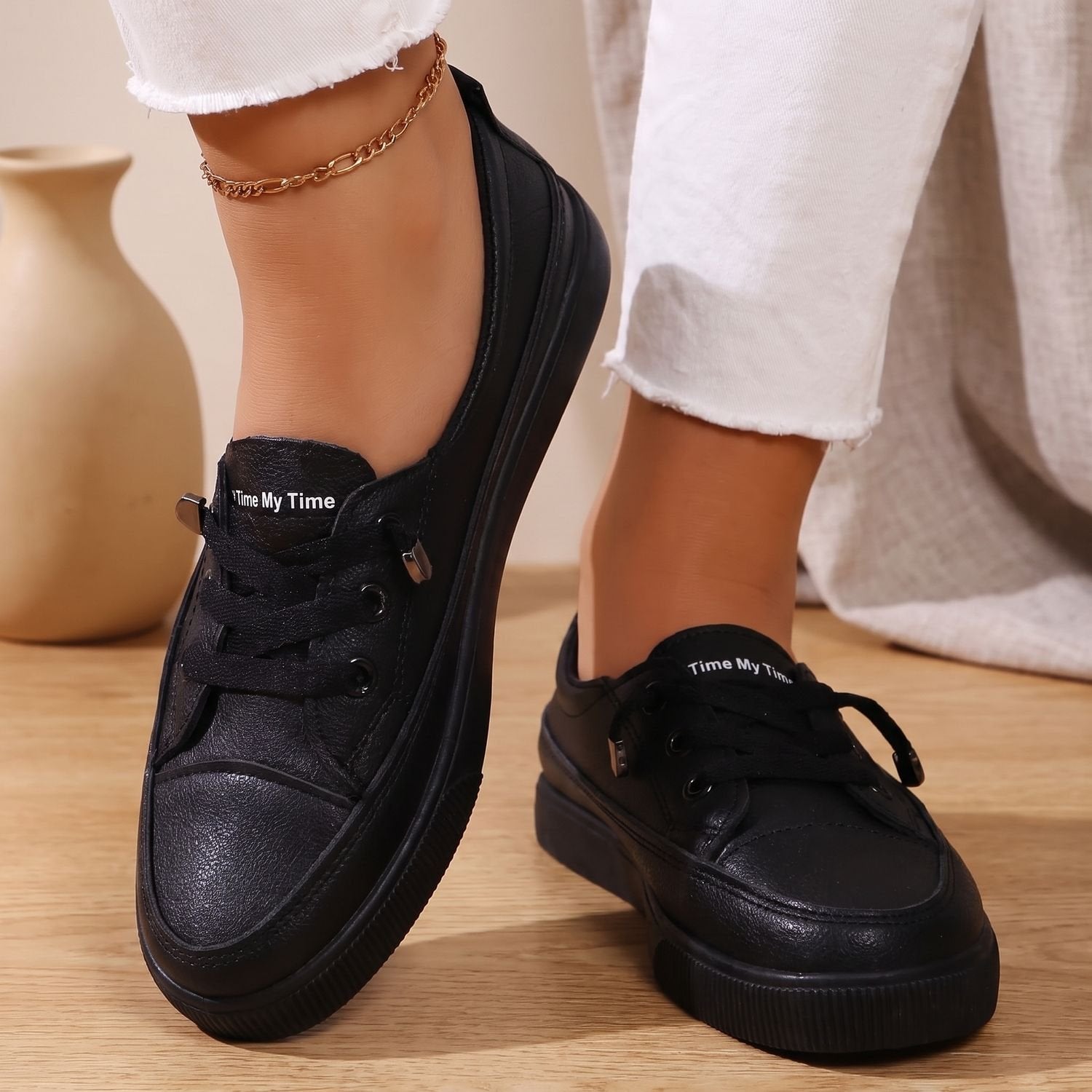 Side profile of a flat women's sneaker with a supportive sole