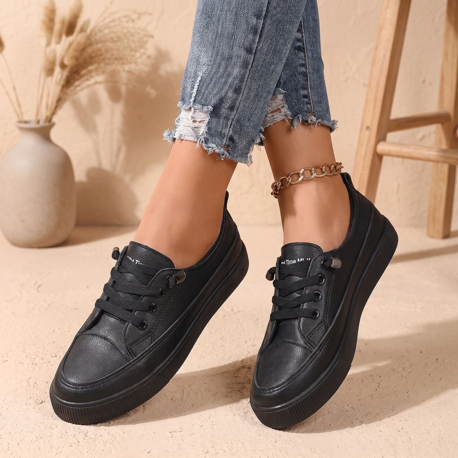 Women's faux leather sneakers shown with their low-profile design