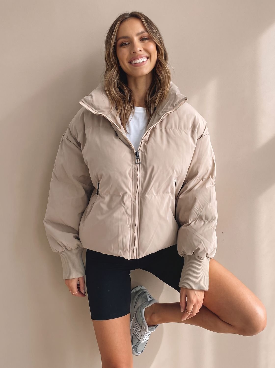 Women's puffer jacket shown in a casual outdoor outfit