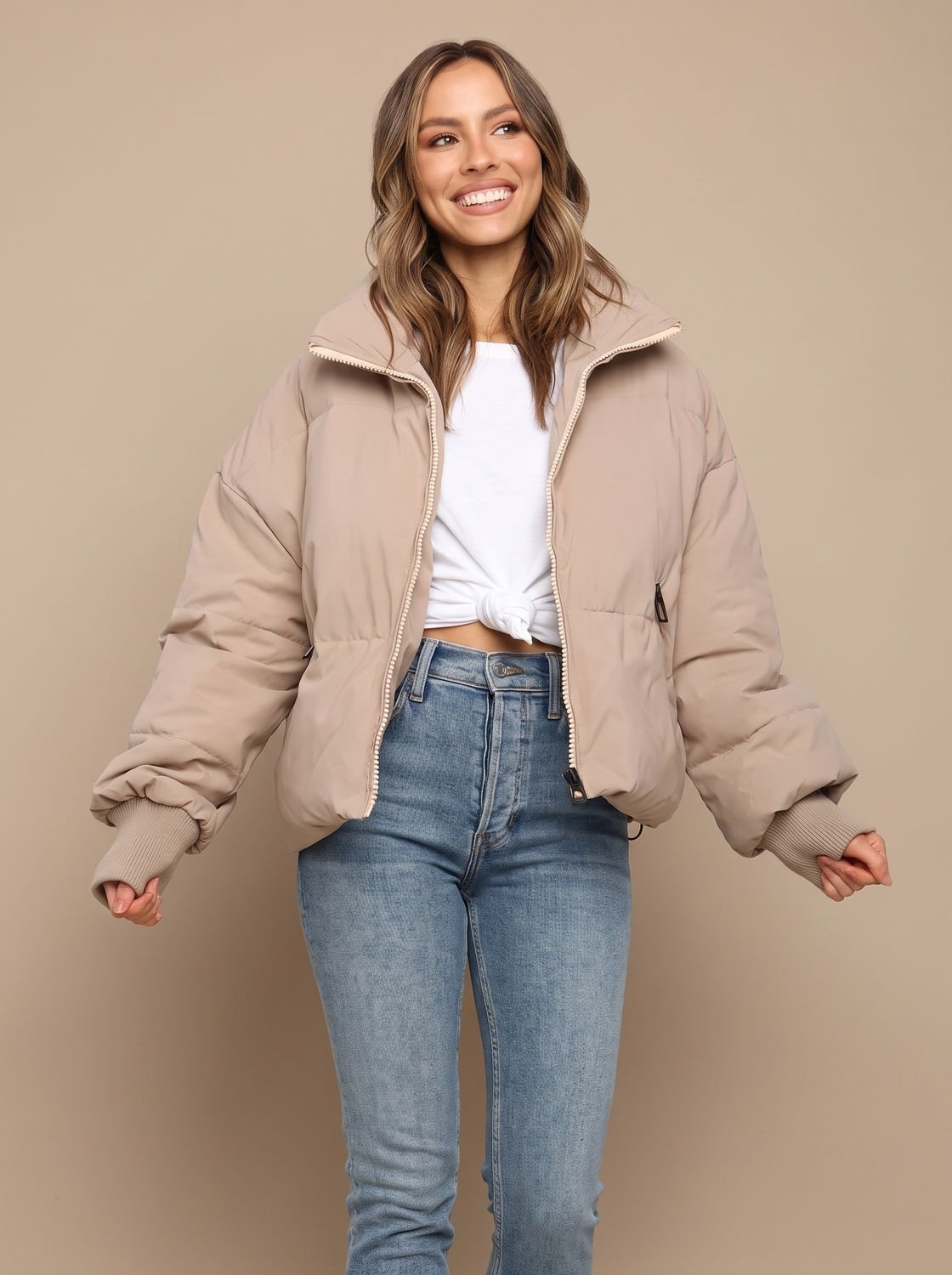 Women's oversized puffer jacket shown from the front with a stand collar
